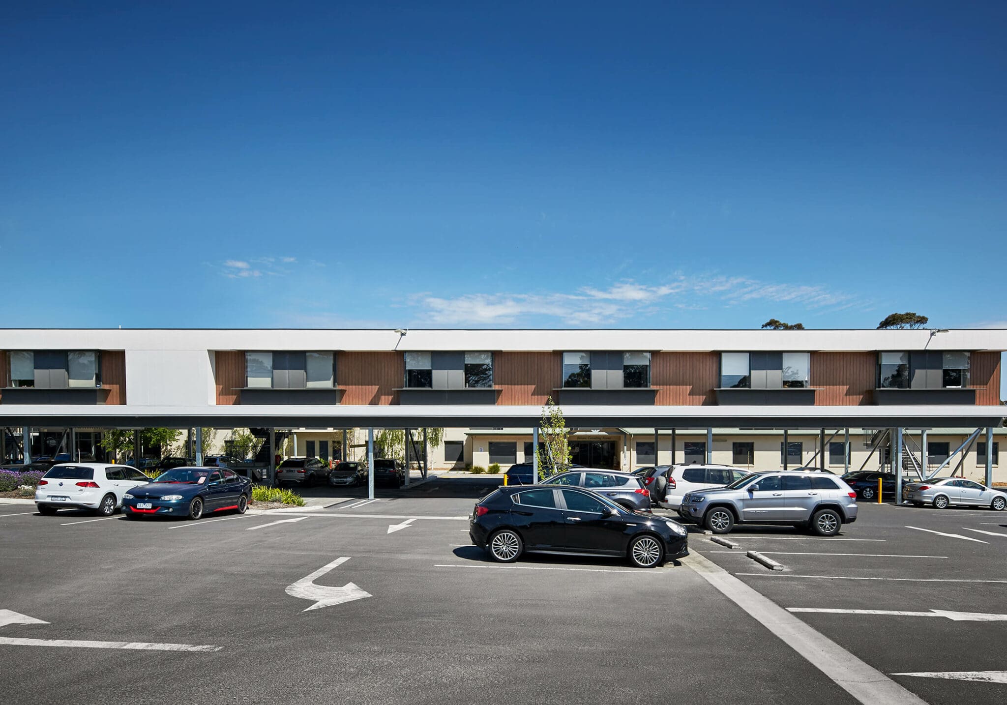 a building with cars parked in a parking lot