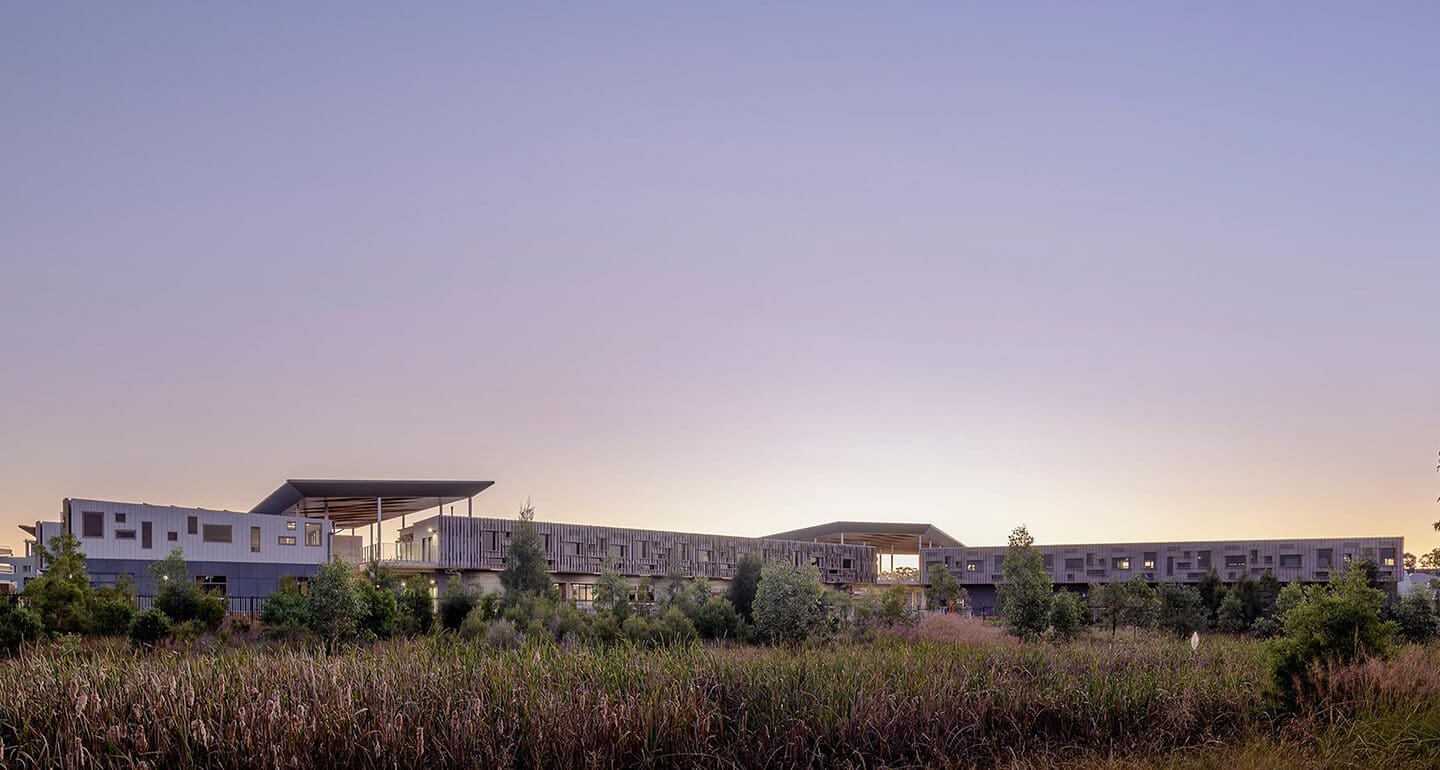 a building with trees and grass