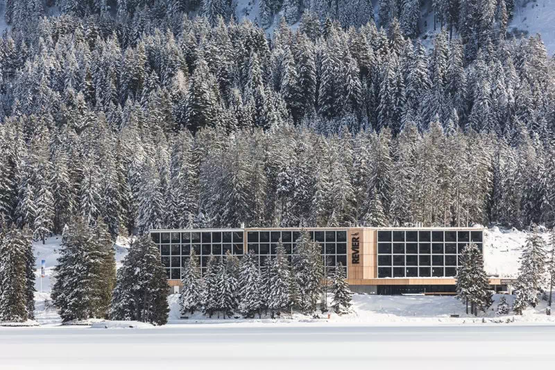 Hotel Revier sitting amongst snow-capped fir trees