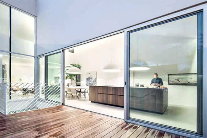 The house's four levels comprise a small square basement, a rectangular ground floor, an L-shaped first floor and a small upper-level mezzanine. Image via T B A