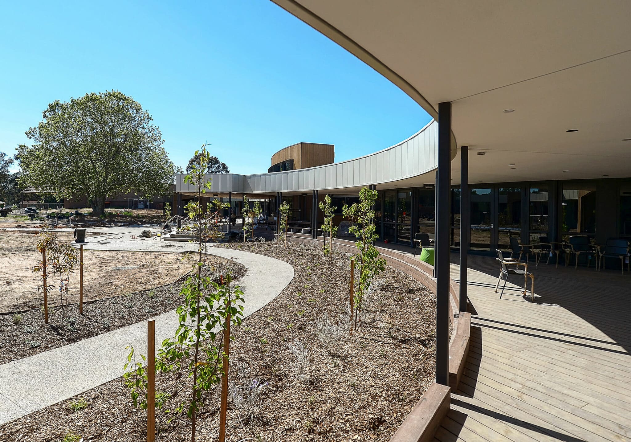 a building with a walkway and trees