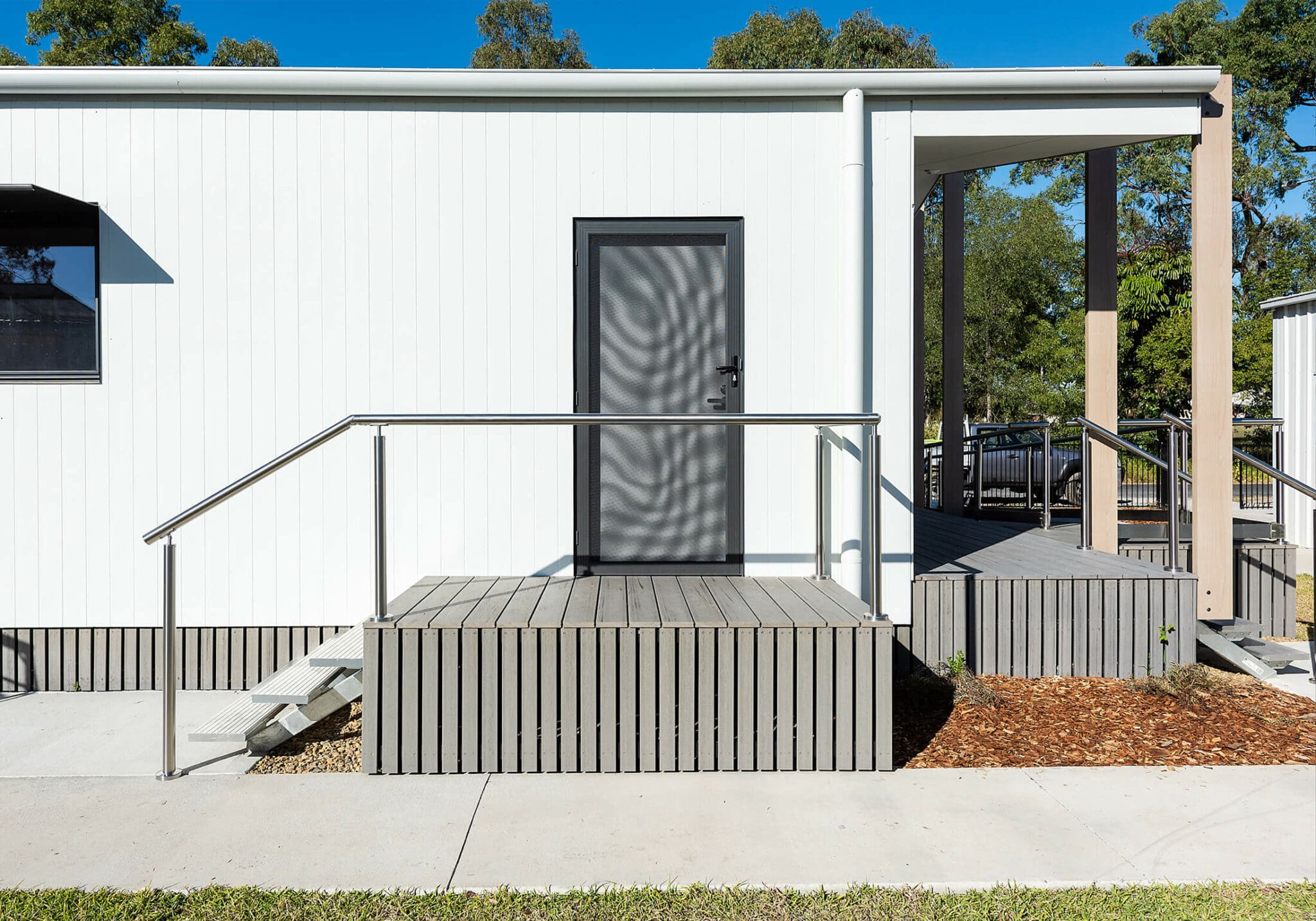 a white building with a grey door