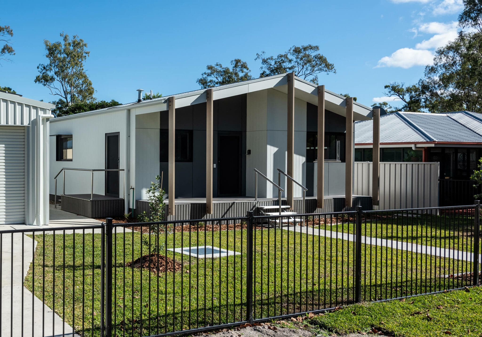a house with a fence and grass